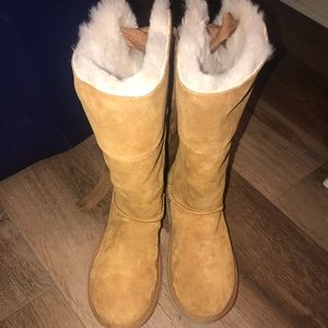 Tan UGG boots with white fur interior